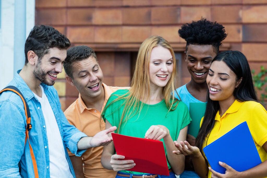 Group of latin and african american students talking about homew