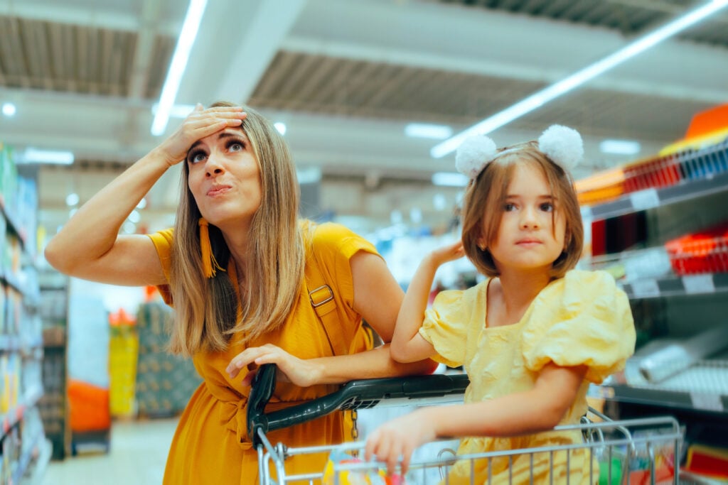 Stressed Mother Feeling Overwhelmed During a Supermarket Shopping Spree