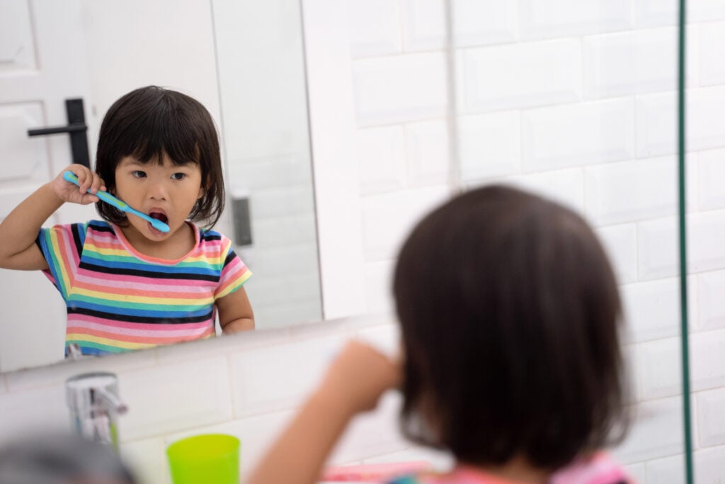 toddler independently brush her own teeth
