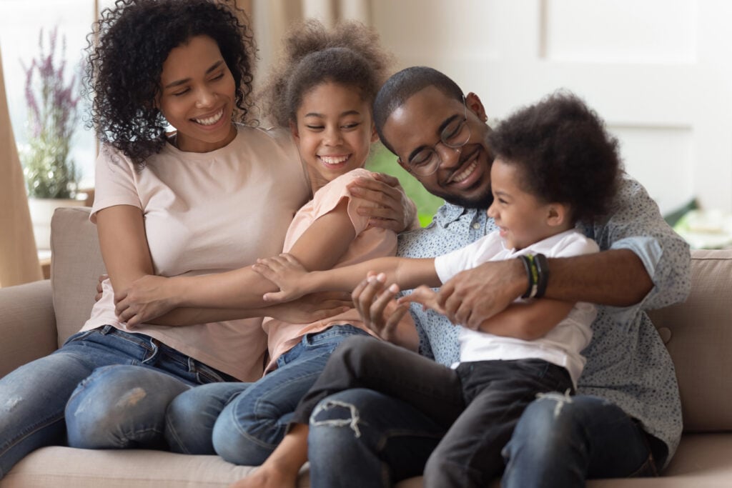 Cheerful african family funny spending time together at home