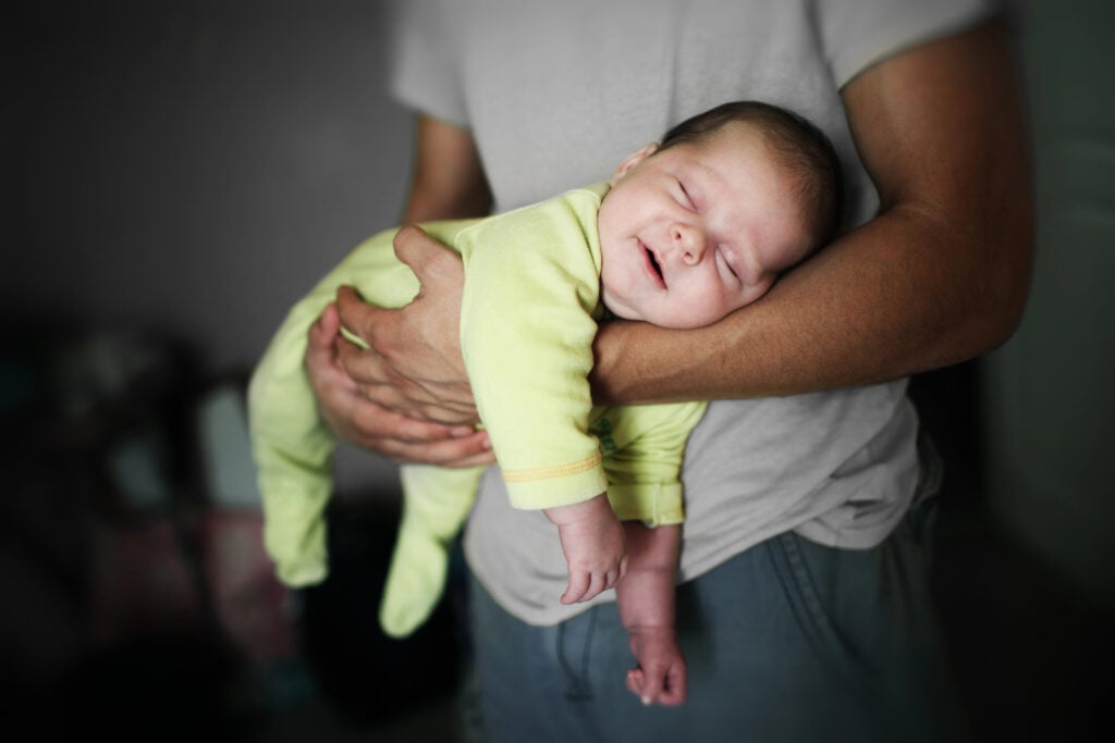 Father holding a sleeping baby