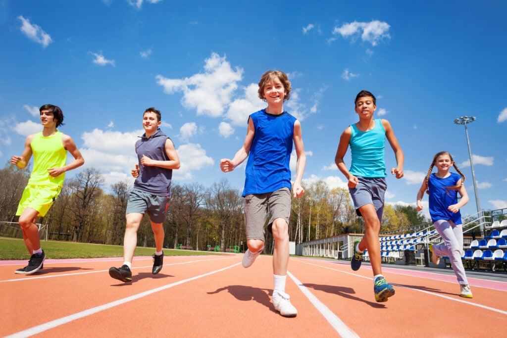 teenage kids running on stadium
