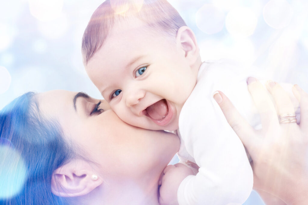Happy mother with baby in hands