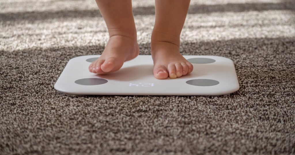 The legs of the child on the scales