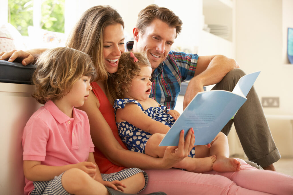 Parents Sitting With Children Reading Story