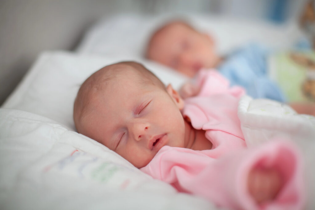 Two adorable twin babies sleeping