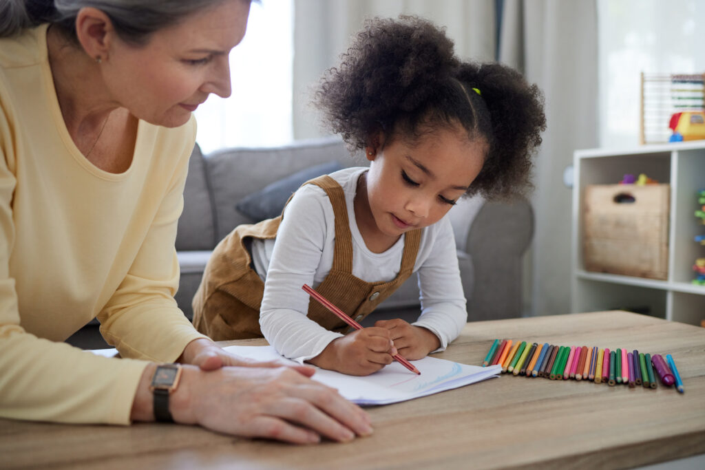 Therapy, child and development with drawing for education, learning behavior and assessment for adhd. Psychologist, mature therapist or girl with crayons for autism, creative activity or motor skills.