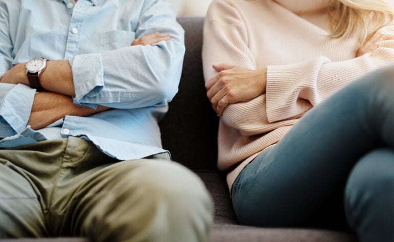 Man and woman going through a divorce, sitting side by side.