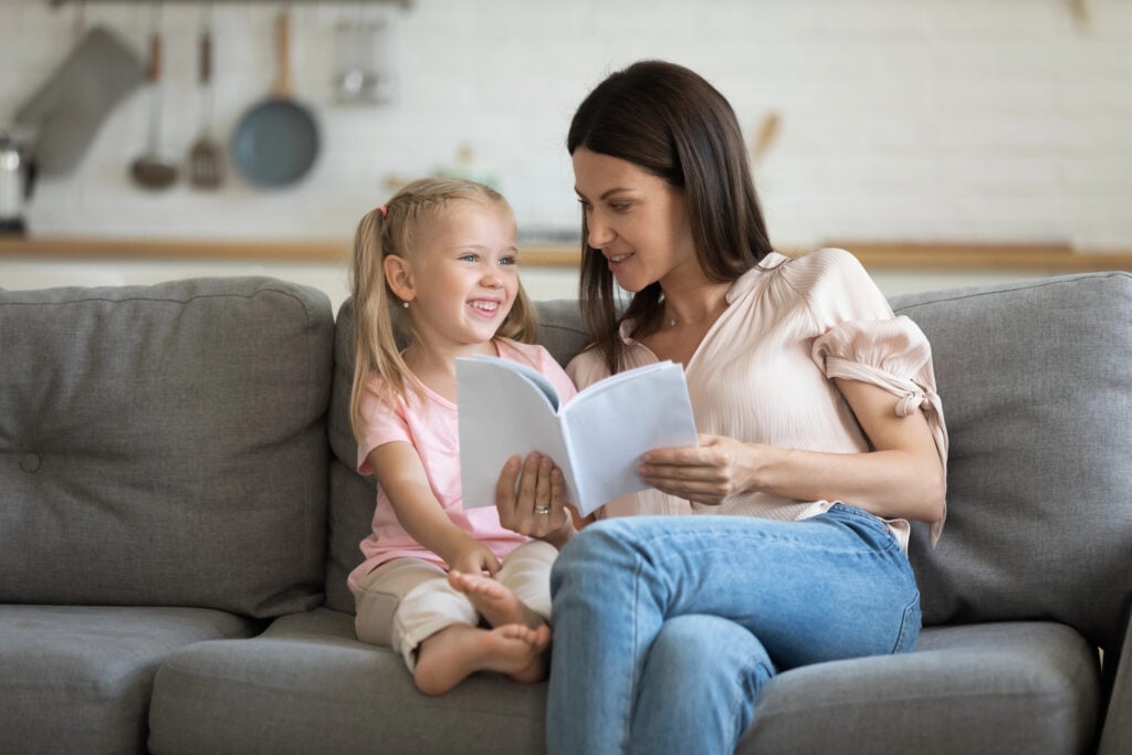 mom asking daughter questions about a book