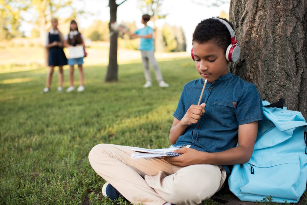 african american boy studying in park