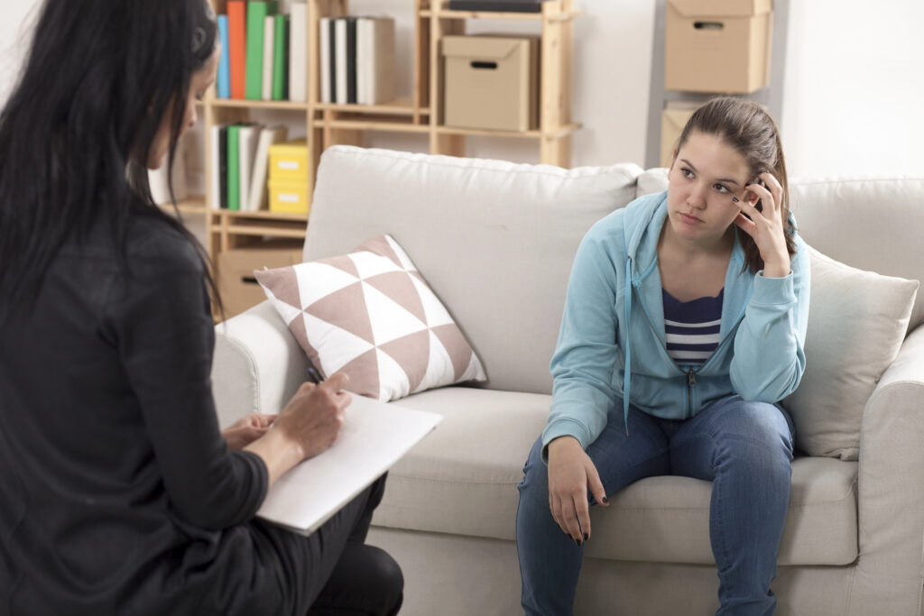 Young teenage girl with psychologist on therapy
