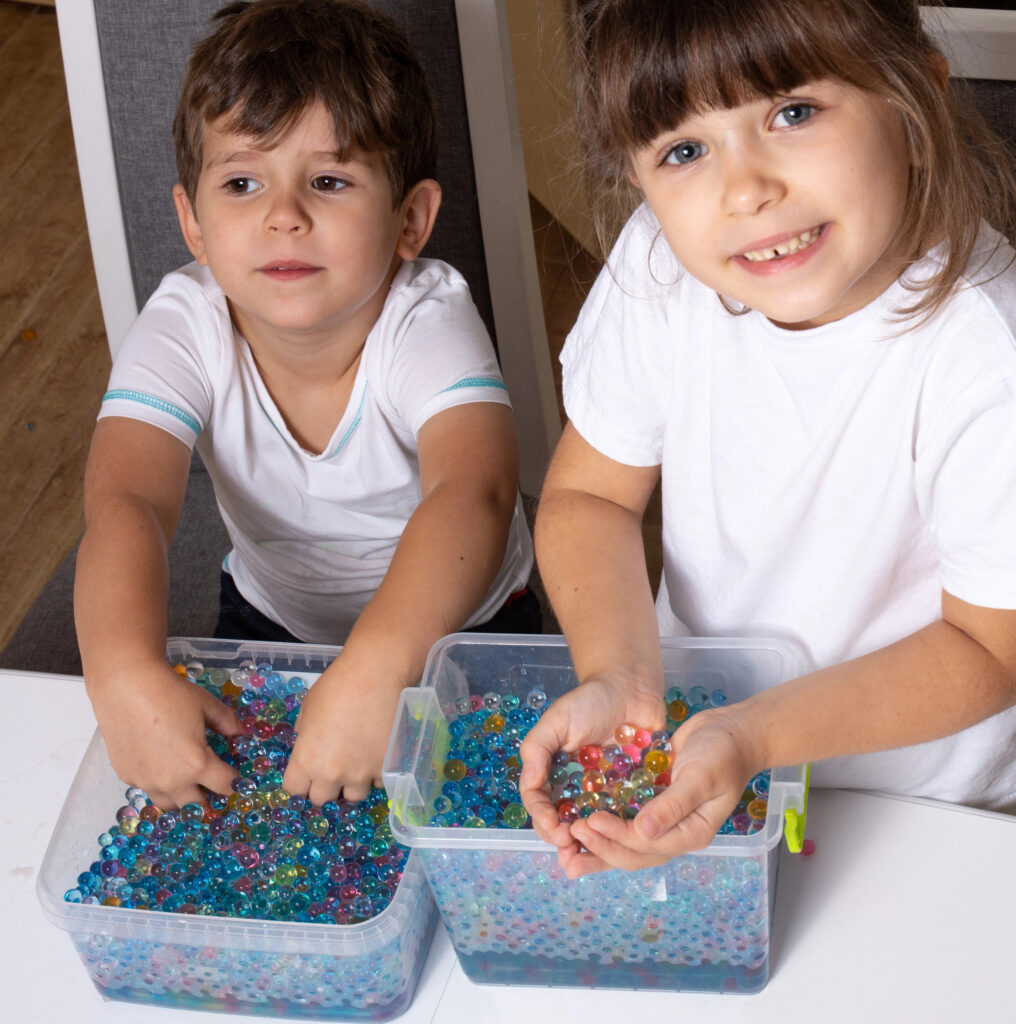 Children playing orbeez. Orbeez balls - sensory water beads.