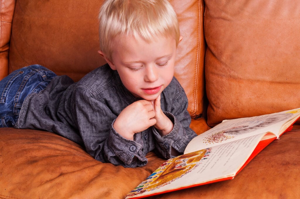 little boy reading a book