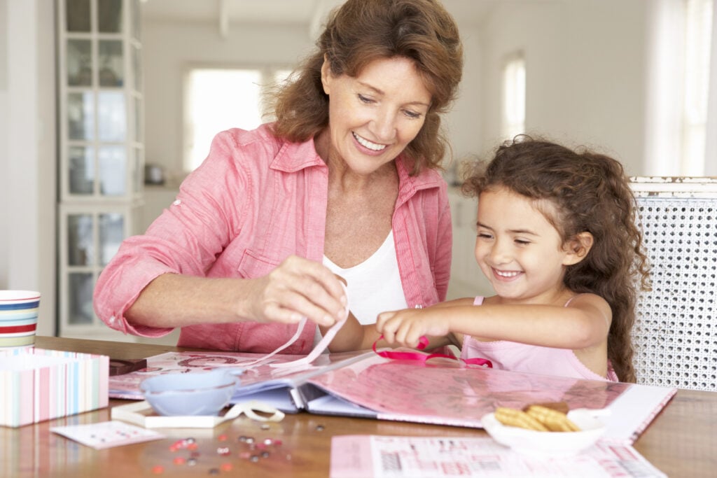 Woman scrapbooking with granddaughter
